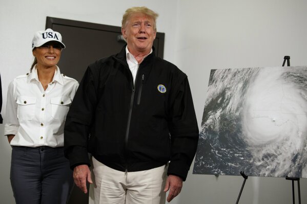 
              First lady Melania Trump looks on as President Donald Trump reacts to a question about Sen. Elizabeth Warren from a reporter during a briefing with state and local officials on the response to Hurricane Michael, Monday, Oct. 15, 2018, Macon, Ga. (AP Photo/Evan Vucci)
            
