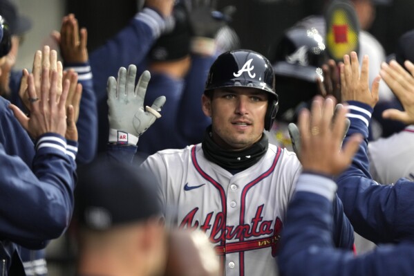 Atlanta Braves' Austin Riley is greeted in the dugout after his three-run home run off Chicago White Sox relief pitcher Dominic Leone in the eighth inning of a baseball game Monday, April 1, 2024, in Chicago. (AP Photo/Charles Rex Arbogast)