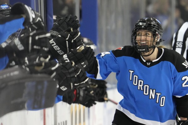Toronto's Natalie Spooner celebrates after her second goal against Ottawa with teammates on the bench during third-period PWHL hockey game action in Toronto, Sunday, May 5, 2024. (Frank Gunn/The Canadian Press via AP)