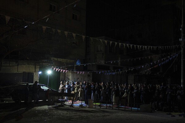 Muslim worshippers perform "tarawih," an extra lengthy prayer held during the Muslim holy month of Ramadan, in Rafah, Gaza Strip, Sunday, March 10, 2024. (AP Photo/Fatima Shbair)