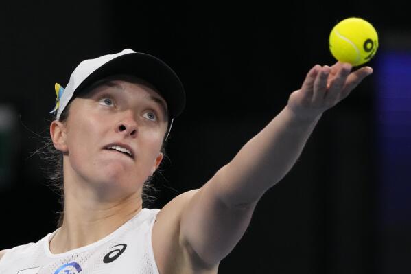 FILE - Poland's Iga Swiatek serves to Jessica Pegula during their semifinal match at the United Cup tennis event in Sydney, Australia, Friday, Jan. 6, 2023. The 2023 Grand Slam season begins at the Australian Open next week. (AP Photo/Mark Baker, File)