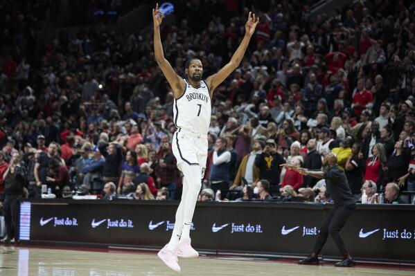 Brooklyn Nets forward Kevin Durant reacts after scoring against the Portland Trail Blazers during the second half of an NBA basketball game in Portland, Ore., Thursday, Nov. 17, 2022. (AP Photo/Craig Mitchelldyer)