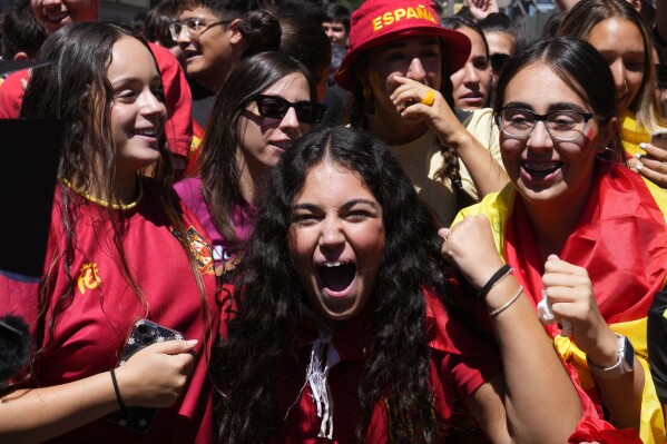 Spanish fans celebrate in a street, in Madrid, Spain, Sunday, Aug. 20, 2023, after Spain won against England in the Women's World Cup final soccer match played in Australia. (AP Photo/Paul White)