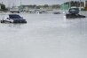 Vehicles sit abandoned in floodwater covering a major road in Dubai, United Arab Emirates, Wednesday, April 17, 2024. Heavy thunderstorms lashed the United Arab Emirates on Tuesday, dumping over a year and a half's worth of rain on the desert city-state of Dubai in the span of hours as it flooded out portions of major highways and its international airport. (AP Photo/Jon Gambrell)