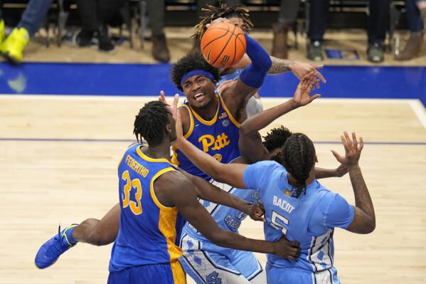 Pittsburgh forward Blake Hinson, center, is fouled as he goes to the basket during the second half of an NCAA college basketball game against North Carolina in Pittsburgh, Friday, Dec. 30, 2022. Pittsburgh won 76-74. (AP Photo/Gene J. Puskar)