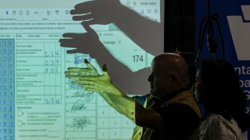 Electoral authorities review electoral records projected on a screen, on the third day of a review of electoral records, in Guatemala City, Thursday, July 6, 2023. The Constitutional Court ordered the investigation of alleged irregularities claimed by political parties that lost in the June 25th general election. (AP Photo/Moises Castillo)