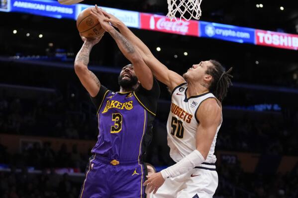 Los Angeles Lakers forward Anthony Davis (3) shoots against Denver Nuggets forward Aaron Gordon (50) during the first half of an NBA basketball game in Los Angeles, Friday, Dec. 16, 2022. (AP Photo/Ashley Landis)