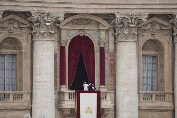 Pope Leo XIV appears at the central balcony of St. Peter's Basilica for his first Sunday blessing after his election, in St. Peter¥s Square at the Vatican, Sunday May 11, 2025. (AP Photo/Alessandra Tarantino)