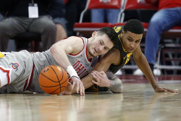 Ohio State forward Kyle Young, left, works for a loose ball against Iowa forward Keegan Murray during the first half of an NCAA college basketball game in Columbus, Ohio, Saturday, Feb. 19, 2022. (AP Photo/Paul Vernon)