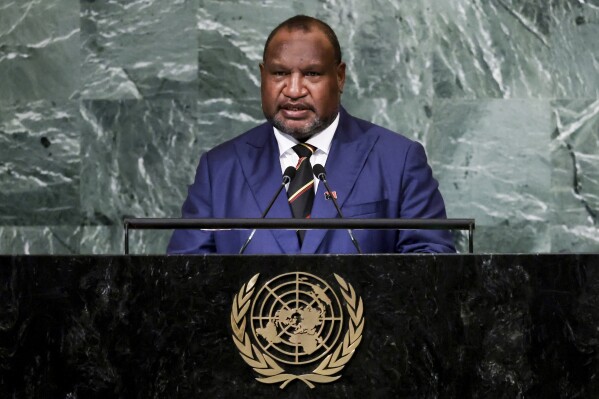 CORRECTS TO DELETE THE DEATH TOLL AS THE NUMBER HAS LOWERED AFTER MORE REPORT - FILE - Prime Minister of Papua New Guinea James Marape addresses the 77th session of the United Nations General Assembly, Sept. 22, 2022, at U.N. headquarters. Multiple people were massacred in a major escalation of tribal violence in Papua New Guinea, Australian media reported Monday, Feb. 19, 2024. Tribal violence in the Enga region has intensified since elections in 2022 that maintained Prime Minister James Marape's administration. (AP Photo/Julia Nikhinson, File)
