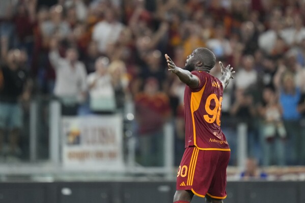 Roma's Romelu Lukaku celebrates with Roma's Diego Llorente after scoring his side's sixth goal during a Serie A soccer match between Roma and Empoli, at Rome's Olympic stadium, Sunday, Sept. 17, 2023. (AP Photo/Alessandra Tarantino)
