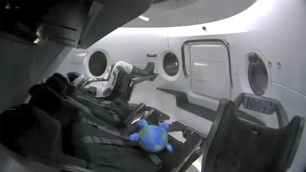
              This photo provided by SpaceX shows a life-size test dummy along with a toy that is floating in the Dragon capsule as the capsule made orbit on Saturday, March 2, 2019.   America's newest capsule for astronauts rocketed toward the International Space Station on a high-stakes test flight by SpaceX.  This latest, flashiest Dragon is on a fast track to reach the space station Sunday morning, just 27 hours after liftoff.  (SpaceX via AP)
            