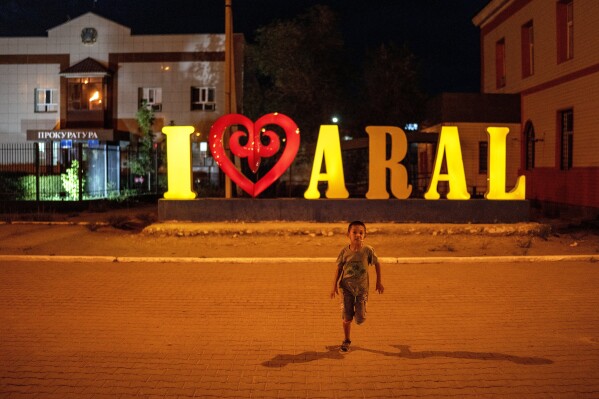 A child runs in Aralsk, Kazakhstan, Tuesday, July 4, 2023. (AP Photo/Ebrahim Noroozi)