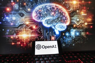 FILE - The OpenAI logo is displayed on a cell phone with an image on a computer monitor generated by ChatGPT's Dall-E text-to-image model, Friday, Dec. 8, 2023, in Boston. The maker of ChatGPT is now diving into the world of AI-generated video. Meet Sora — OpenAI’s new text-to-video generator. The tool, which the San Francisco-based company unveiled on Thursday, Feb. 16, 2024 uses generative artificial intelligence to instantly create short videos based on written commands. (AP Photo/Michael Dwyer, File)
