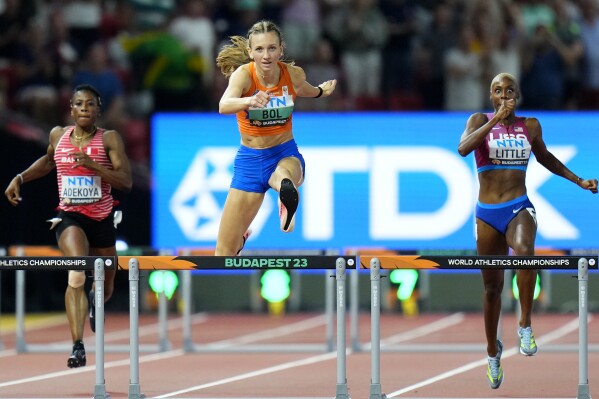 Femke Bol, of the Netherlands, center, races to win the gold medal in the final of the Women's 400-meters hurdles during the World Athletics Championships in Budapest, Hungary, Thursday, Aug. 24, 2023. (AP Photo/Petr David Josek)