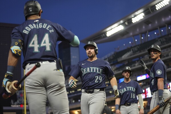 Seattle Mariners' Cal Raleigh (29) celebrates with teammates after hitting a grand slam during the seventh inning of a baseball game against the Minnesota Twins,Tuesday, May 7, 2024, in Minneapolis. (AP Photo/Abbie Parr)