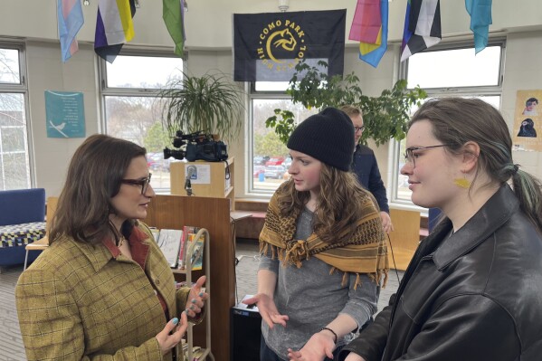 Bloomington Jefferson senior Shae Ross, center, joined Lieutenant Governor Peggy Flanagan, left, at an event promoting proposed legislation to prevent books bans based on ideology at Como Park High School in St. Paul, Minn., on March 21, 2024. (Chris Williams/Education Minnesota via AP)