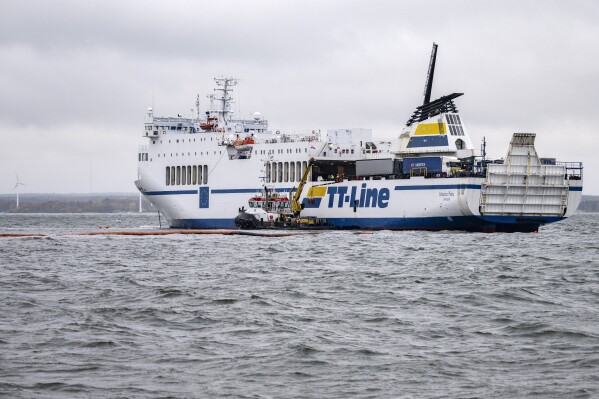 The grounded ferry Marco Polo and the tug Max are seen outside Horvik, southern Sweden on Oct. 26, 2023. The Swedish Coast Guard says a ferry boat that ran aground twice off the southeastern coast of Sweden is leaking oil and has suffered “extensive damage.” The Marco Polo ferry, which was running between two Swedish ports on the Baltic Sea, touched ground on Oct. 22. (Johan Nilsson/TT News Agency via AP)