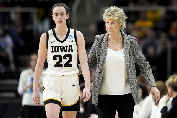 Iowa head coach Lisa Bluder, right, talks with guard Caitlin Clark (22) during the fourth quarter of a Sweet Sixteen round college basketball game against Colorado during the NCAA Tournament, Saturday, March 30, 2024, in Albany, N.Y. (AP Photo/Mary Altaffer)