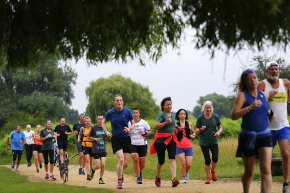 People take part in the Park Run at Bushy Park in London, Saturday July 24, 2021, one of many runs taking place across the country for the first time since March 2020 when the event was closed due to the COVID-19 pandemic. (Victoria Jones/PA via AP)