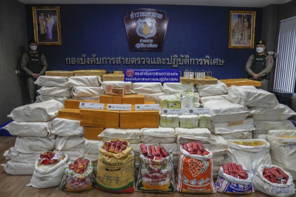 FILE - Thai police officers stand behind packages containing seized crystal meth, methamphetamine, heroin during a news conference Bangkok, Thailand, on Sept. 28, 2023.The U.N. drug fighting agency says East and Southeast Asia are awash in record amounts of methamphetamine and other synthetic drugs, originating largely from the cross-border area known as the Golden Triangle, historically known for growing opium and hosting many of the labs that converted it to heroin. (AP Photo/Sakchai Lalit)