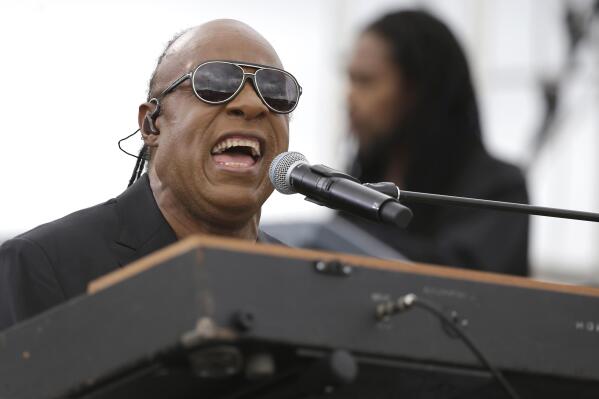 FILE - In this  Sunday, Nov. 6, 2016 file photo, Musician Stevie Wonder performs at a campaign rally for Democratic presidential candidate Hillary Clinton before President Barack Obama spoke to the audience in Kissimmee, Fla. Stevie Wonder will headline Global Citizen Live’s star-studded 24-hour event in Los Angeles this month to help raise money and make a plea for increased COVID-19 vaccine doses along with bringing awareness toward climate change and poverty. Global Citizen officials announced Thursday, Sept. 9, 2021 that Wonder will be among several performers – including H.E.R., Adam Lambart and Demi Lovato – to take part in the event at The Greek Theatre on Sept. 25. (AP Photo/John Raoux, File)