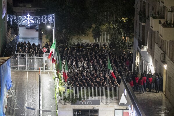 People gather during a rally to commemorate the slaying in 1978 of two members of a neo-fascist youth group in an attack later claimed by extreme-left militants, in Rome, Sunday Jan. 7, 2024. Opposition politicians in Italy demanded on Monday that Italy's government explain how hundreds of demonstrators were able to give a banned fascist salute at a Rome rally without any police intervention. (Francesco Benvenuti/LaPresse via AP)