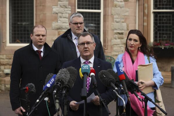From left, Gordon Lyons MLA, Gavin Robinson MP, Sir Jeffrey Donaldson MP and Emma Little-Pengelly MLA speak to the media outside the Culloden Hotel where Prime Minister Rishi Sunak is holding talks with Stormont leaders over the Northern Ireland Protocol, in Belfast, Northern Ireland, Friday Feb. 17, 2023. (Liam McBurney/PA via AP)