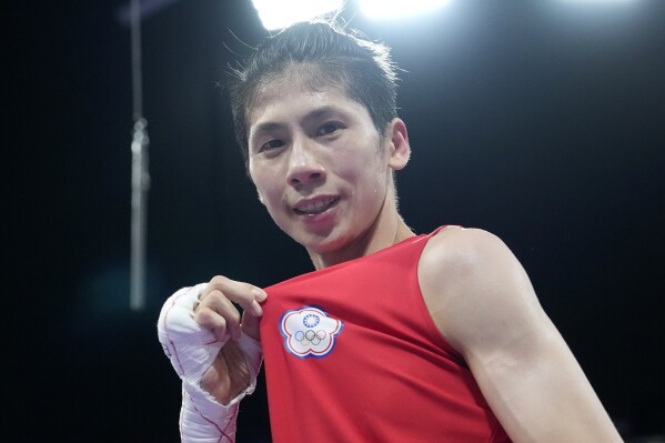 Taiwan's Lin Yu-ting celebrates after defeating Bulgaria's Svetlana Staneva in their women's 57 kg quarterfinal boxing match at the 2024 Summer Olympics, Sunday, Aug. 4, 2024, in Paris, France. (AP Photo/Ariana Cubillos)