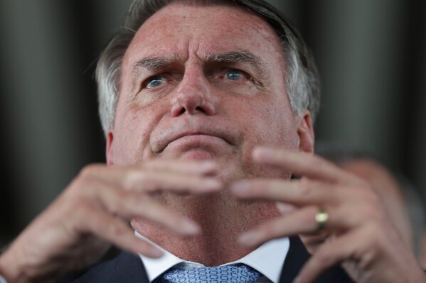 Brazil's former President Jair Bolsonaro speaks to the press at Congress in Brasilia, Brazil, Wednesday, March 26, 2025, after panel of Brazil Supreme Court justices accepted charges against him over an alleged attempt to stay in office after his 2022 election defeat. (AP Photo/Luis Nova)