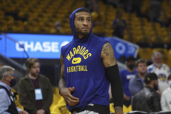 Injured Golden State Warriors guard Gary Payton II watches players warm up before Game 2 of his team's NBA basketball playoffs Western Conference finals against the Dallas Mavericks in San Francisco, Friday, May 20, 2022. (AP Photo/Jed Jacobsohn)