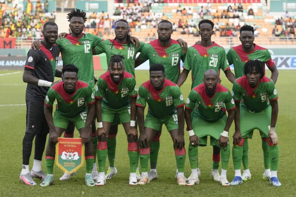 Burkina Faso starting players pose for a team photo at the beginning of the African Cup of Nations round of 16 soccer match between Mali and Burkina Faso, at the Amadou Gon Coulibaly stadium in Korhogo, Ivory Coast, Tuesday, Jan. 30, 2024. (AP Photo/Themba Hadebe)