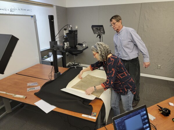 This photo provided by RB Toth Associates shows researchers using imaging technology on 1300 Magna Carta copies to uncover invisible details for humans on March 19, 2024 at Weissmann Preservation Center in Cambridge, Massachusetts (RB Toth Associates via the AP)