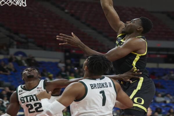 Oregon center N'Faly Dante, right, shoots over Michigan State guard Pierre Brooks (1) and center Mady Sissoko (22) during the first half of an NCAA college basketball game in the Phil Knight Invitational tournament in Portland, Ore., Friday, Nov. 25, 2022. (AP Photo/Craig Mitchelldyer)