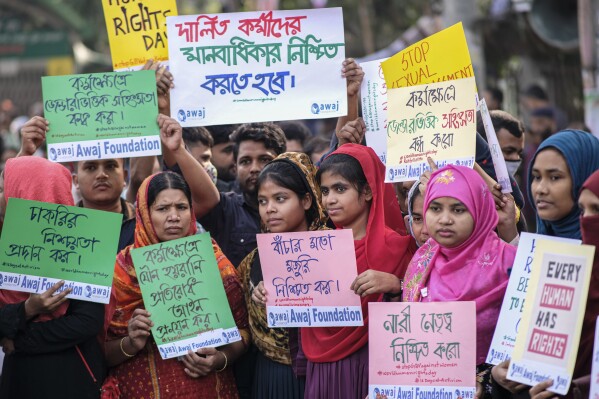 A group of garment workers join as supporters of Bangladesh Nationalist Party (BNP) form a human chain marking International Human Rights Day in Dhaka, Bangladesh, Sunday, Dec.10, 2023. The opposition allege that thousands of their activists have been detained by security agencies ahead of the country's general election on Jan. 7. The BNP, led by former Prime Minister Khaleda Zia, is boycotting the election leaving voters in the South Asian nation of 166 million with little choice but to re-elect Prime Minister Sheikh Hasina's Awami League for a fourth consecutive term. (AP Photo/ Mahmud Hossain Opu)
