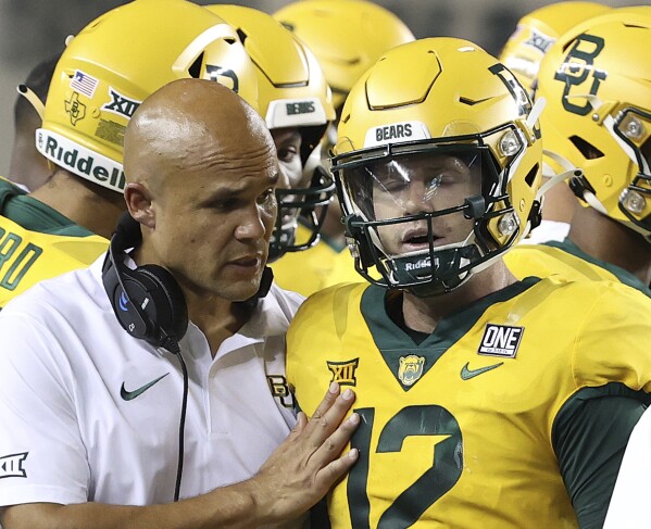 Baylor coach Dave Aranda speaks with quarterback Blake Shapen (12), who is pulled from the NCAA college football game against Texas State during in the second half Saturday, Sept. 3, 2023, in Waco, Texas. (Jerry Larson/Waco Tribune-Herald via AP)