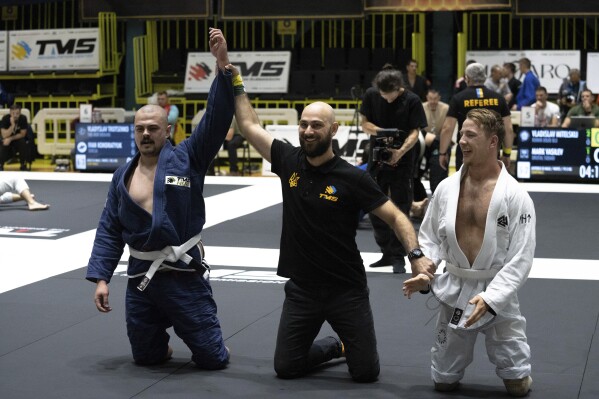 Ukrainian war veterans with amputated limbs perform at the Ukrainian national competition of jiu jitsu in Kiev, Ukraine, on Sunday, Oct. 29, 2023.  More than 20,000 people in Ukraine have lost limbs due to injuries since the beginning of the Russian war, many of them soldiers.  Some of them have learned to deal with their psychological trauma by practicing a form of Brazilian Jiu-Jitsu.  (AP Photo/Roman Hrytsyna)