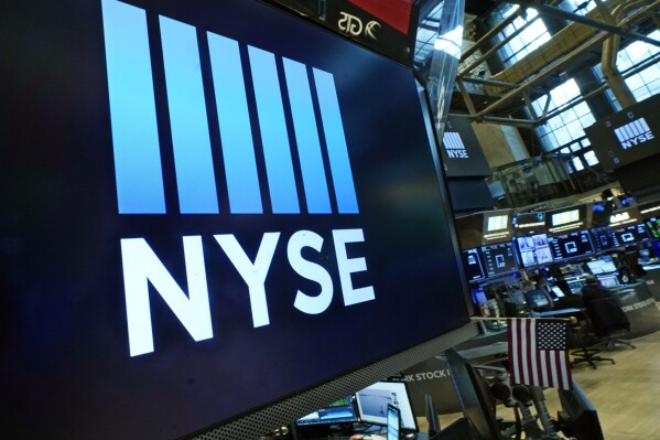FILE - Logos the New York Stock Exchange adorn trading posts, on the floor, Wednesday, March 16, 2022. Stocks are off to mixed start on Wall Street, Thursday, April 7, as several major technology stocks rose even as many other parts of the market were in the red. (APPhoto/Richard Drew, File)