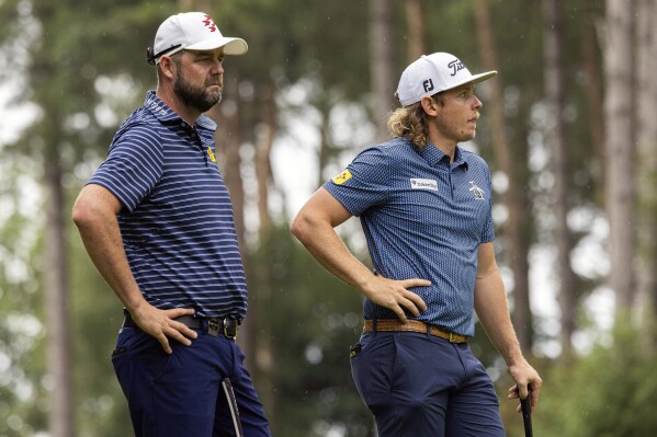 Marc Leishman, left, of Ripper GC and captain Cameron Smith of Ripper GC wait on the first green during the second round of LIV Golf London at the Centurion Club on Saturday, July 8, 2023, in Hemel Hempstead, England. (Photo by Chris Trotman/LIV Golf via AP)
