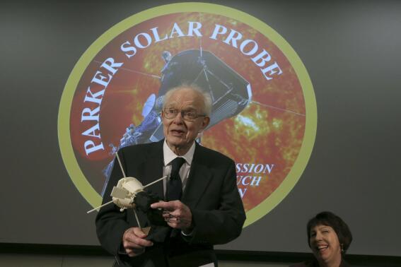 FILE-Eugene Parker, professor emeritus at the University of Chicago, holds a replica of the Parker Solar Probe, named after him, at the William Eckhardt Research Center at the University of Chicago, Wednesday, May 31, 2017. Parker, whose contributions to solar physics were so enormous that NASA named its Parker Solar Probe mission after him, died Tuesday, March 15, 2022. He was 94. (Antonio Perez/Chicago Tribune via AP)
