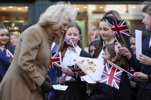 FILE - Britain's Queen Camilla meets the public during her visit to Deacon & Son Jewelers in Swindon, western England, Monday, Jan. 22, 2024, as the company celebrates 175 years in business.  Queen Camilla, once seen as the scourge of the House of Windsor, the woman at the heart of King Charles III's doomed marriage to the late Princess Diana, has become one of the monarchy's most prominent emissaries.  (Adrian Dennis/Pool Photo via AP, File)