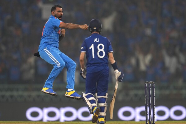 India's Mohammed Shami, left, celebrates the wicket of England's Moeen Ali , right, during the ICC Men's Cricket World Cup match between India and England in Lucknow, India, Sunday, Oct. 29, 2023. (AP Photo/Manish Swarup)