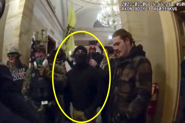 This image from police-worn body camera, and provided and annotated by the Justice Department, in the sentencing memo for Nathaniel Tuck, shows Tuck, circled in yellow, inside the U.S. Capitol Jan. 6, 2021, in Washington. (Department of Justice via AP)