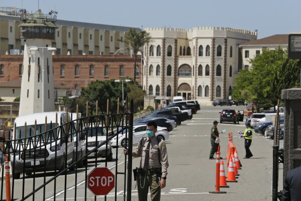 FILE - A correctional officer closes the main gate at San Quentin State Prison in San Quentin, Calif., July 9, 2020. The U.S. Supreme Court on Monday, May 13, 2024, denied an appeal from California corrections officials who sought immunity from lawsuits claiming they acted with deliberate indifference when they caused a deadly COVID-19 outbreak at one of the world's most famous prisons four years ago. (AP Photo/Eric Risberg, File)