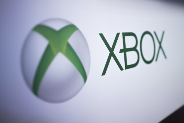 FILE - The Xbox logo is pictured at the Paris Games Week in Paris, Nov. 3, 2017. Several exclusive Xbox games will be soon making their way to rival consoles, the video gaming brand and its parent company Microsoft announced Thursday, Feb. 15, 2024. (APPhoto/Kamil Zihnioglu, File)