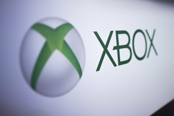 FILE - The Xbox logo is pictured at the Paris Games Week in Paris, Nov. 3, 2017. Several exclusive Xbox games will be soon making their way to rival consoles, the video gaming brand and its parent company Microsoft announced Thursday, Feb. 15, 2024. (AP Photo/Kamil Zihnioglu, File)