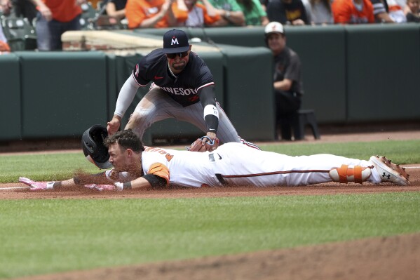 Minnesota Twins third baseman Royce Lewis tags put Baltimore Orioles' Ryan Mountcastle at third as Mountcastle tried to stretch a double into a triple during the fourth inning of a baseball game, Thursday, May 15, 2025, in Baltimore(AP Photo/Daniel Kucin Jr.)
