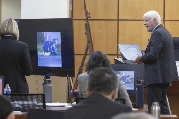 Grant Fredericks, right a video forensic expert, testifies what is happening in still images taken from a video of the arrest of Manny Ellis during the trial of Tacoma Police officers Christopher Burbank, Matthew Collins and Timothy Rankine in the killing of Ellis, Wednesday, Oct. 4, 2023, at Pierce County Superior Court, Tacoma, Wash. (Ellen M. Banner/The Seattle Times via AP, Pool)