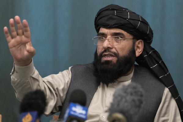FILE - In this March 19, 2021 file photo, Suhail Shaheen, Afghan Taliban spokesman and a member of the negotiation team gestures while speaking during a joint news conference in Moscow, Russia. In an interview with The Associated Press Thursday, July 22, 2021, Shaheen said the insurgent movement does not want to monopolize power, but there won't be peace until there is a new, negotiated government in Kabul and Afghan President Ashraf Ghani is removed. Shaheen said women will be allowed to work, go to school, and participate in politics but will have to wear the hijab, or headscarf. (AP Photo/Alexander Zemlianichenko, Pool, File)
