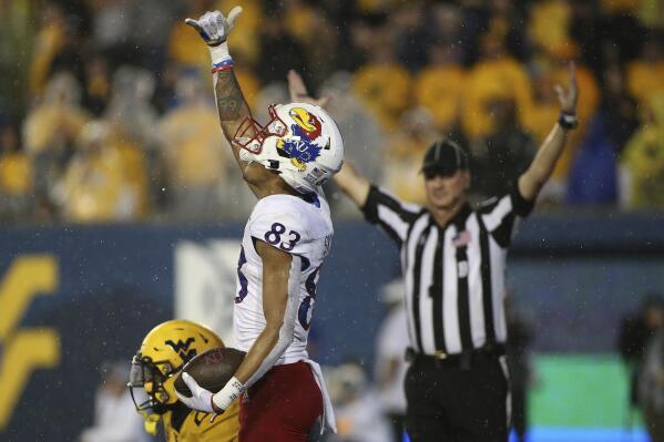 Kansas wide receiver Quentin Skinner (83) celebrates after a touchdown during overtime of an NCAA college football game against West Virginia in Morgantown, W.Va., Saturday, Sept. 10, 2022. (AP Photo/Kathleen Batten)